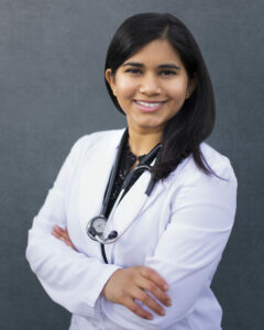 Dr. Maryanne D'Silva, ND headshot in lab coat and stethoscope against grey background