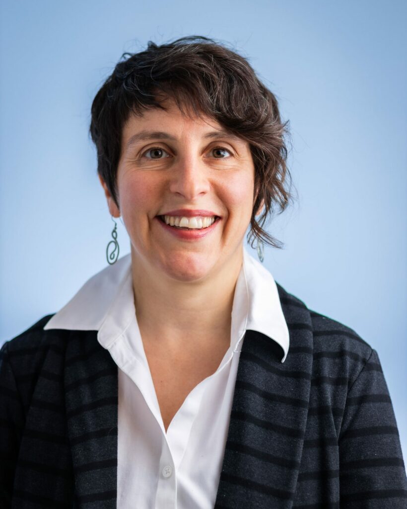 Dr. Jessica Carfagnini, ND headshot against light blue background